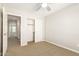 This bedroom has neutral walls, neutral carpet, a ceiling fan, and a closet at 1021 W Vineyard Plains Dr, San Tan Valley, AZ 85143