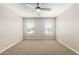 This bedroom has neutral walls, neutral carpet, and two windows with blinds at 1021 W Vineyard Plains Dr, San Tan Valley, AZ 85143