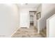 Inviting entryway features wood-look tile, a front door, and stairs to the upper level at 1021 W Vineyard Plains Dr, San Tan Valley, AZ 85143