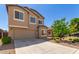 View of a well maintained home with a tree in the front yard, complemented by desert landscaping at 1021 W Vineyard Plains Dr, San Tan Valley, AZ 85143