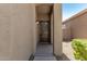 A close-up of the home's front door, framed by a covered entrance and textured walls at 1021 W Vineyard Plains Dr, San Tan Valley, AZ 85143