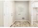Bright laundry room features wood-look tile, a window, and washer/dryer hookups at 1021 W Vineyard Plains Dr, San Tan Valley, AZ 85143