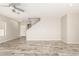 Spacious living room features wood-look tile flooring, neutral walls, and a modern ceiling fan at 1021 W Vineyard Plains Dr, San Tan Valley, AZ 85143