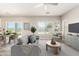 Living room showcases stylish gray sofa, plants, and serene decor with sliding glass door at 1021 W Vineyard Plains Dr, San Tan Valley, AZ 85143