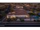 Aerial view showcases a home with a sparkling pool, manicured lawn, and outdoor entertaining area at 10511 E Diffraction Ave, Mesa, AZ 85212