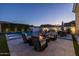 Backyard patio with comfortable seating, dining area, and a fire pit, perfect for outdoor entertaining and relaxation at 10511 E Diffraction Ave, Mesa, AZ 85212