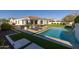 Beautiful backyard with a sparkling pool, lounge chairs, outdoor dining area, and lush landscaping for ultimate relaxation at 10511 E Diffraction Ave, Mesa, AZ 85212