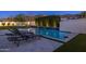 Inviting backyard pool with lounge chairs, lush green grass, and a privacy wall with cascading water features at 10511 E Diffraction Ave, Mesa, AZ 85212