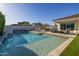 Stunning backyard with a modern pool, spa, outdoor seating, and lush landscaping, creating a serene oasis at 10511 E Diffraction Ave, Mesa, AZ 85212