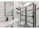 Stylish bathroom featuring modern fixtures, a glass-enclosed shower, and elegant shiplap accents at 10511 E Diffraction Ave, Mesa, AZ 85212