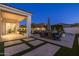 Expansive covered patio with outdoor dining area, fire pit, and views of the lush backyard and sparkling pool at 10511 E Diffraction Ave, Mesa, AZ 85212
