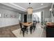 Bright dining room with wood table, modern lighting, and a seamless indoor-outdoor transition at 10511 E Diffraction Ave, Mesa, AZ 85212