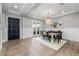 Stylish dining area featuring modern chandelier, open layout, and easy access to the outdoor patio at 10511 E Diffraction Ave, Mesa, AZ 85212