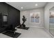 A home exercise room is complete with modern exercise equipment, a dark accent wall, and ample space at 10511 E Diffraction Ave, Mesa, AZ 85212