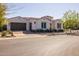 Charming single-story home with a brown tile roof, arched entryway, and a meticulously manicured front yard at 10511 E Diffraction Ave, Mesa, AZ 85212