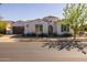 Charming single-story home featuring a brown tile roof, arched entryway, and a well-maintained front yard at 10511 E Diffraction Ave, Mesa, AZ 85212
