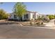 Attractive single-story home featuring a well-kept yard with fresh landscaping and neutral color palette at 10511 E Diffraction Ave, Mesa, AZ 85212