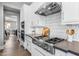 Gourmet kitchen equipped with a stainless steel range hood, sleek cabinetry, and premium appliances for culinary enthusiasts at 10511 E Diffraction Ave, Mesa, AZ 85212