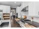 Well-organized kitchen featuring custom cabinetry, a gas cooktop, and convenient storage solutions, blending style and functionality at 10511 E Diffraction Ave, Mesa, AZ 85212