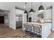 Beautiful kitchen with stainless steel appliances, a large marble island with seating, and modern pendant lighting at 10511 E Diffraction Ave, Mesa, AZ 85212