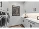 Well-organized laundry room with modern appliances, marble countertops, and ample storage at 10511 E Diffraction Ave, Mesa, AZ 85212