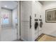 Modern laundry room with white cabinets, barn door, stacked washer and dryer, and neutral paint at 10511 E Diffraction Ave, Mesa, AZ 85212