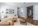Bright living room with neutral tones, wood floors, shiplap, and a cozy layout for relaxation and entertainment at 10511 E Diffraction Ave, Mesa, AZ 85212