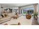 Open-concept living area with a neutral color palette, large sectional sofa, and easy access to the backyard at 10511 E Diffraction Ave, Mesa, AZ 85212