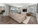 Bright living room with custom built-ins, a large sliding glass door, and comfortable seating area with wood floors at 10511 E Diffraction Ave, Mesa, AZ 85212