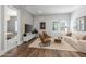 Inviting living room featuring modern decor, wood floors, and shiplap accent wall for a cozy gathering space at 10511 E Diffraction Ave, Mesa, AZ 85212