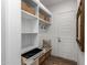 Organized mudroom with built-in shelving, drawers, and a cozy bench for convenient storage and seating at 10511 E Diffraction Ave, Mesa, AZ 85212