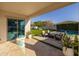 Charming outdoor living space, features patio, green lawn, and adjacent refreshing pool with outdoor seating at 10511 E Diffraction Ave, Mesa, AZ 85212
