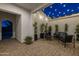 Enclosed patio with comfortable seating, lush plants, and string lights for cozy outdoor living at 10511 E Diffraction Ave, Mesa, AZ 85212