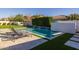 Sparkling pool offers a relaxing outdoor experience, featuring a modern waterfall wall and comfortable lounge chairs at 10511 E Diffraction Ave, Mesa, AZ 85212