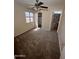 Carpeted bedroom with ceiling fan and view of bathroom at 1053 E Sunburst Ln, Tempe, AZ 85284