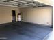 Spacious garage featuring painted floors and ample room for storage and parking at 1053 E Sunburst Ln, Tempe, AZ 85284