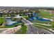 Aerial view of the community with a pond running through the golf course and lush landscaping at 12439 W Yellow Bird Ln, Peoria, AZ 85383