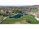 Aerial view of the community with mature landscaping, a pond, and golf course at 12439 W Yellow Bird Ln, Peoria, AZ 85383