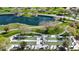 Aerial view of people playing lawn bowling with a pond and golf course visible in the background at 12439 W Yellow Bird Ln, Peoria, AZ 85383