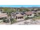 Aerial view of a residential area with solar panels and desert landscaping, highlighting well-maintained homes and community layout at 12439 W Yellow Bird Ln, Peoria, AZ 85383