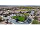 An aerial view of a residential neighborhood highlighting well-maintained homes and landscaping around a green circular space at 12439 W Yellow Bird Ln, Peoria, AZ 85383