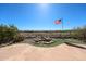 Beautiful backyard featuring a small waterfall and manicured landscaping with an American flag at 12439 W Yellow Bird Ln, Peoria, AZ 85383
