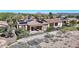 Beautiful backyard with desert landscaping, a patio with a table, and solar panels on the roof, and an American flag at 12439 W Yellow Bird Ln, Peoria, AZ 85383