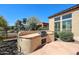 Outdoor kitchen area with a built-in BBQ and countertop in the spacious backyard at 12439 W Yellow Bird Ln, Peoria, AZ 85383
