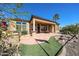 Inviting backyard showcasing lush landscaping, a covered patio, and a custom built in BBQ at 12439 W Yellow Bird Ln, Peoria, AZ 85383