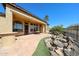 Expansive backyard featuring a water feature, desert landscaping, and a covered patio at 12439 W Yellow Bird Ln, Peoria, AZ 85383