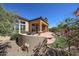 Inviting backyard featuring a covered patio, built-in grill, and lush desert landscaping at 12439 W Yellow Bird Ln, Peoria, AZ 85383