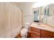 Bright bathroom with a shower/tub combo and wooden vanity at 12439 W Yellow Bird Ln, Peoria, AZ 85383