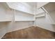 Walk-in closet featuring carpet floors, rod-and-shelf storage, and a large open space at 12439 W Yellow Bird Ln, Peoria, AZ 85383