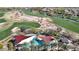 Aerial view of the community pool with shade structures and lounge chairs, nestled among lush landscaping at 12439 W Yellow Bird Ln, Peoria, AZ 85383